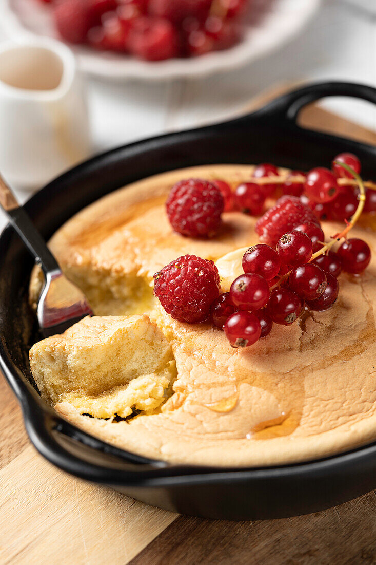 Baked Japanese pancake with honey and berries