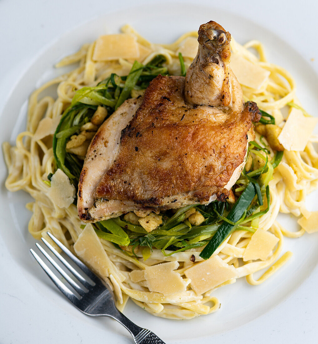 Roasted chicken breast with fettuccine and leeks