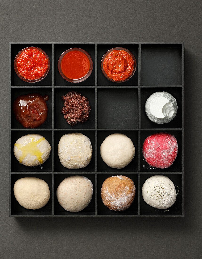 Tray with tomato sauces, tapenade, ricotta and dough balls for pizza