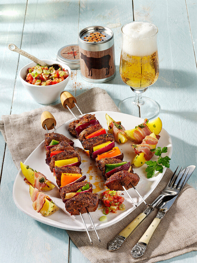 Steak and vegetable skewers with bacon and potatoes