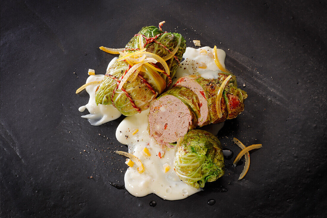 Savoy cabbage roulade with minced beef in lemon sauce