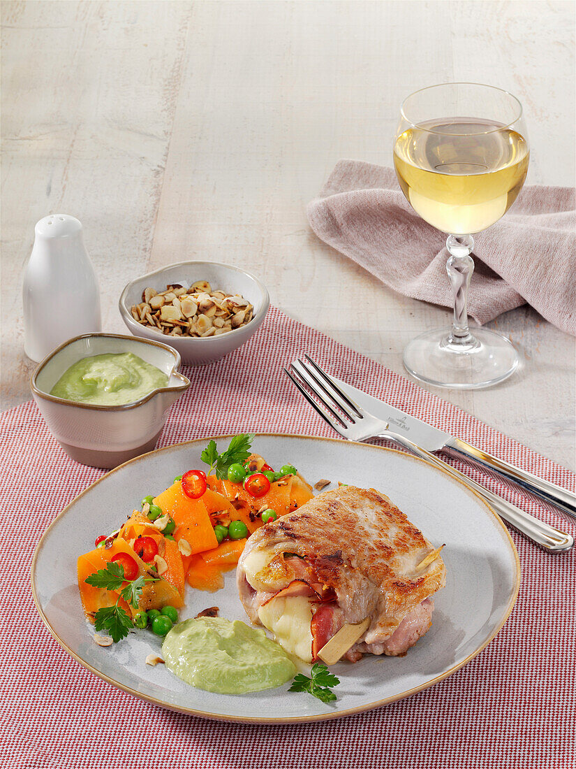 Stuffed pork schnitzel with chili carrots and pea cream