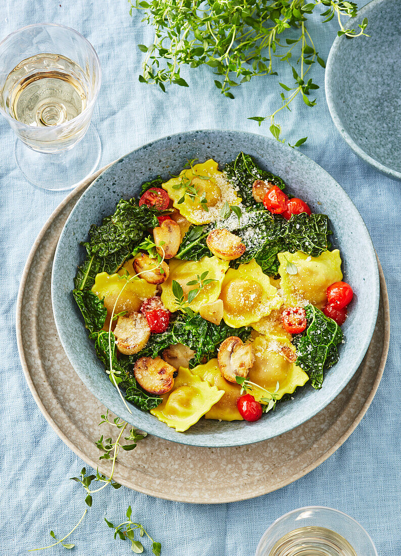 Ravioli with meat filling on kale with thyme