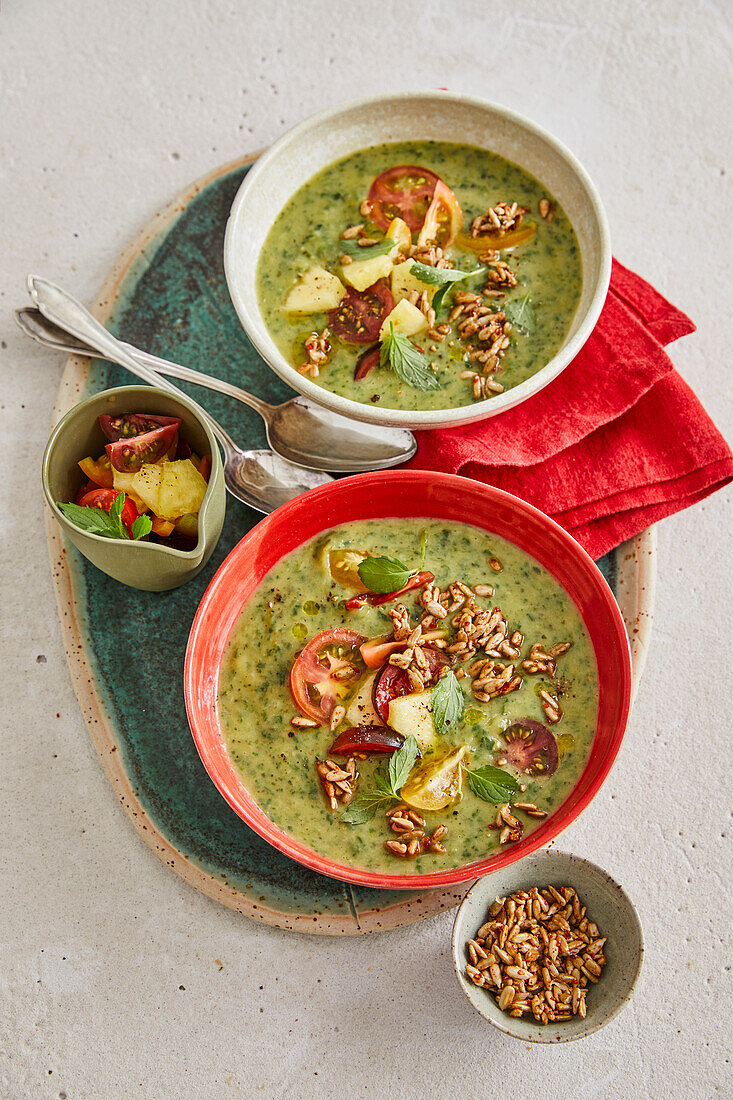 Cold zucchini soup with pineapple and tomato topping