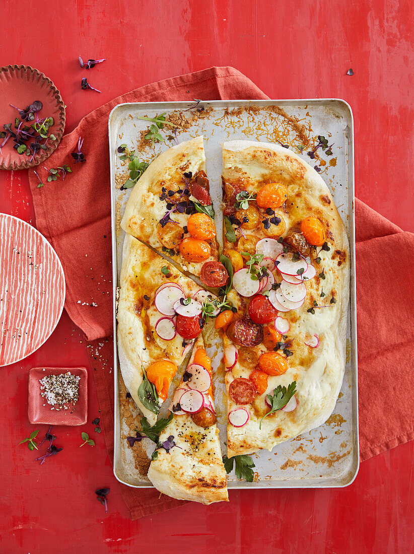 Colourful tomato and taleggio pizza with radishes