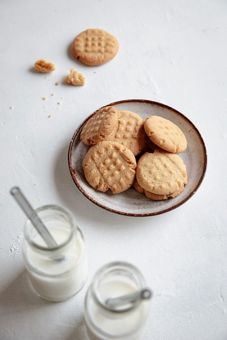 Peanut butter cookies and two bottles of milk