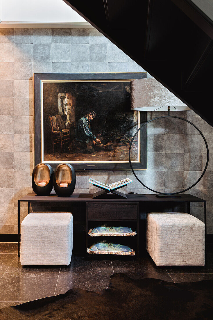 Sideboard with stools in front of historical painting