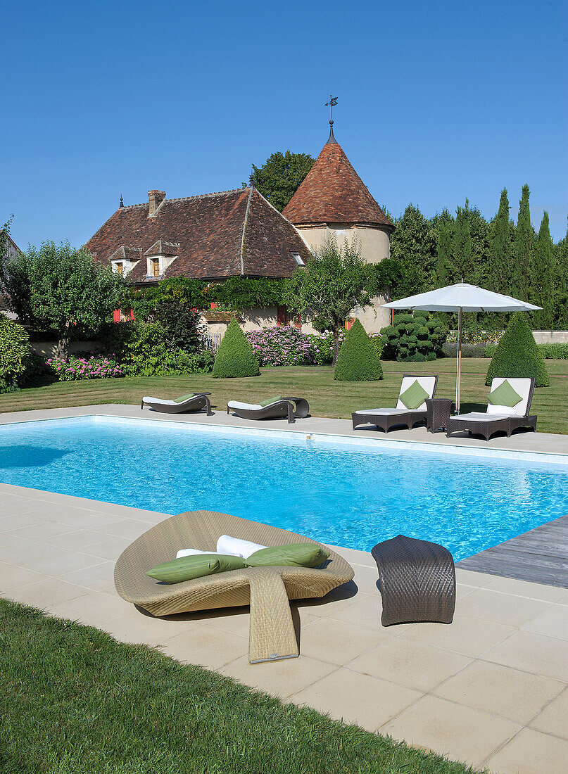 Pool with elegant loungers in the garden