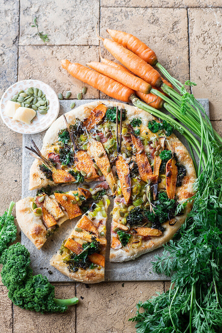 Carrot pizza with leek and pumpkin seeds