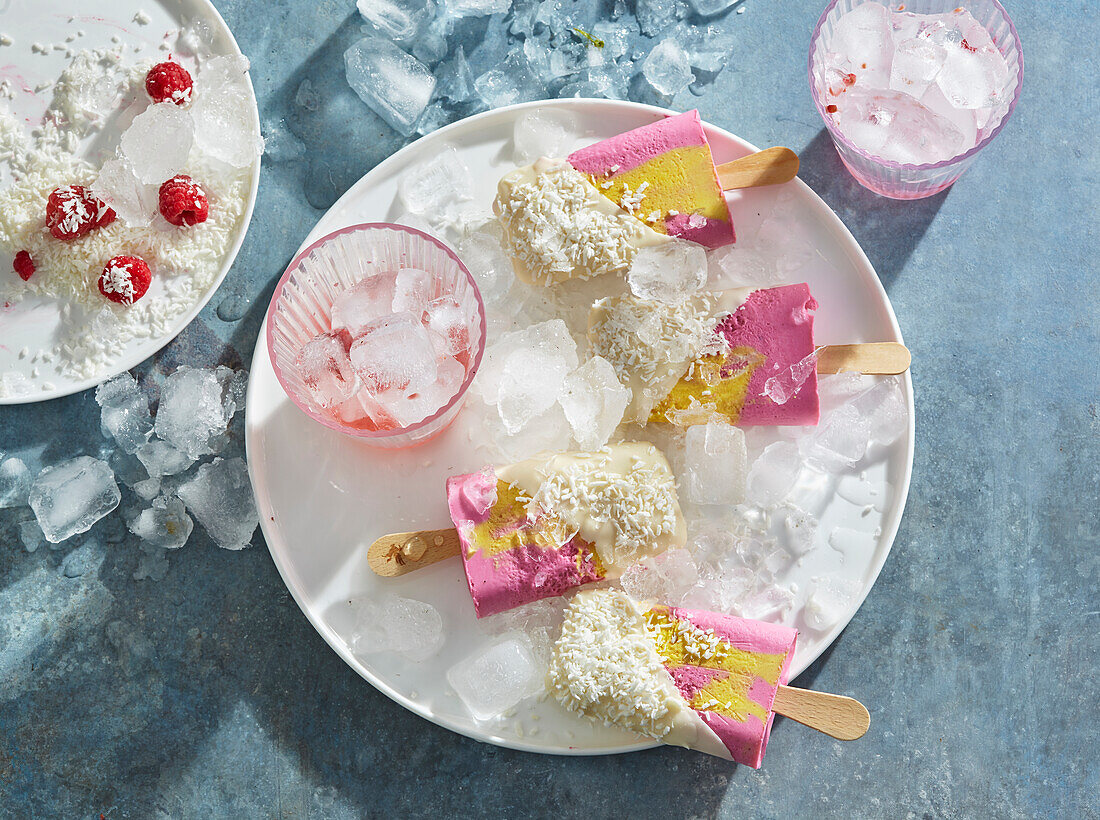 Mango and raspberry ice cream on a stick with white chocolate