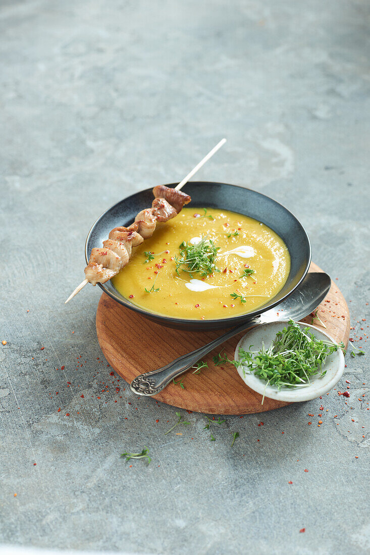 Sweet potato soup with chicken skewers