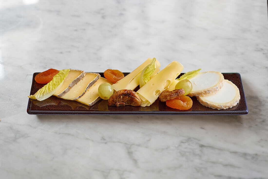 A cheese platter with dried fruits