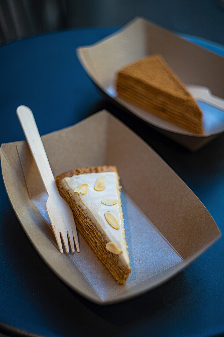 Slice of honey cake in a cardboard tray