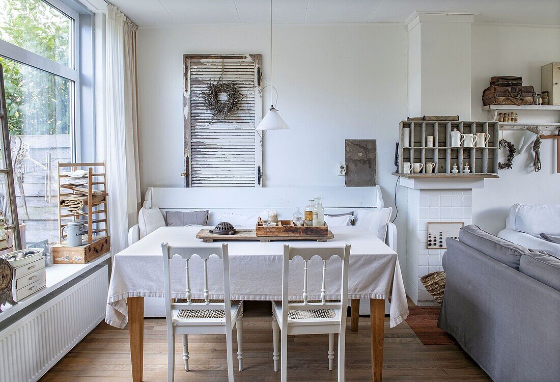 Vintage-style dining area with table, wooden chairs and bench seat