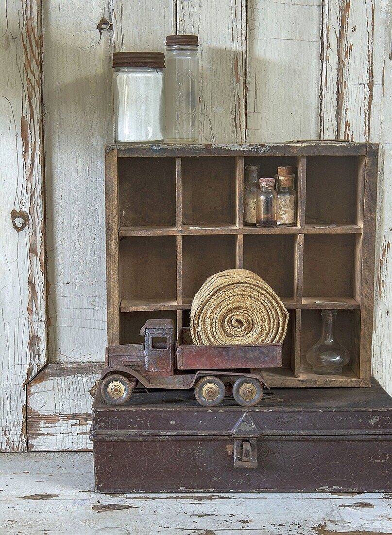 Vintage decorations with toy truck and bottles in a box