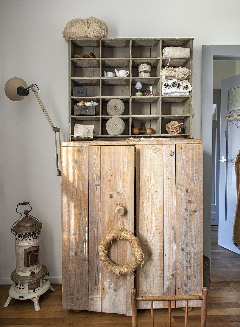 Country-style cupboard with wooden wall shelf and vintage decorations