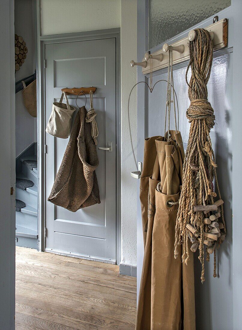 Entrance area with hook strips, vintage decorations and stairs in the background