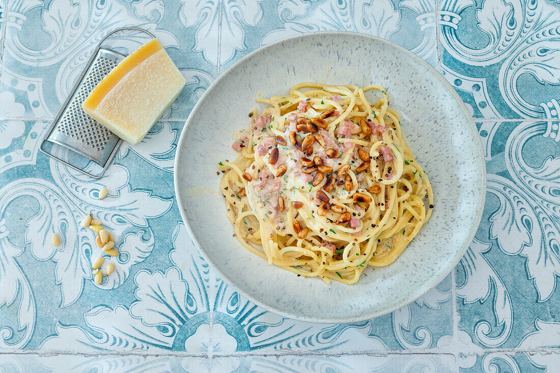 Carbonara with miso paste, bacon and marinated pine nuts