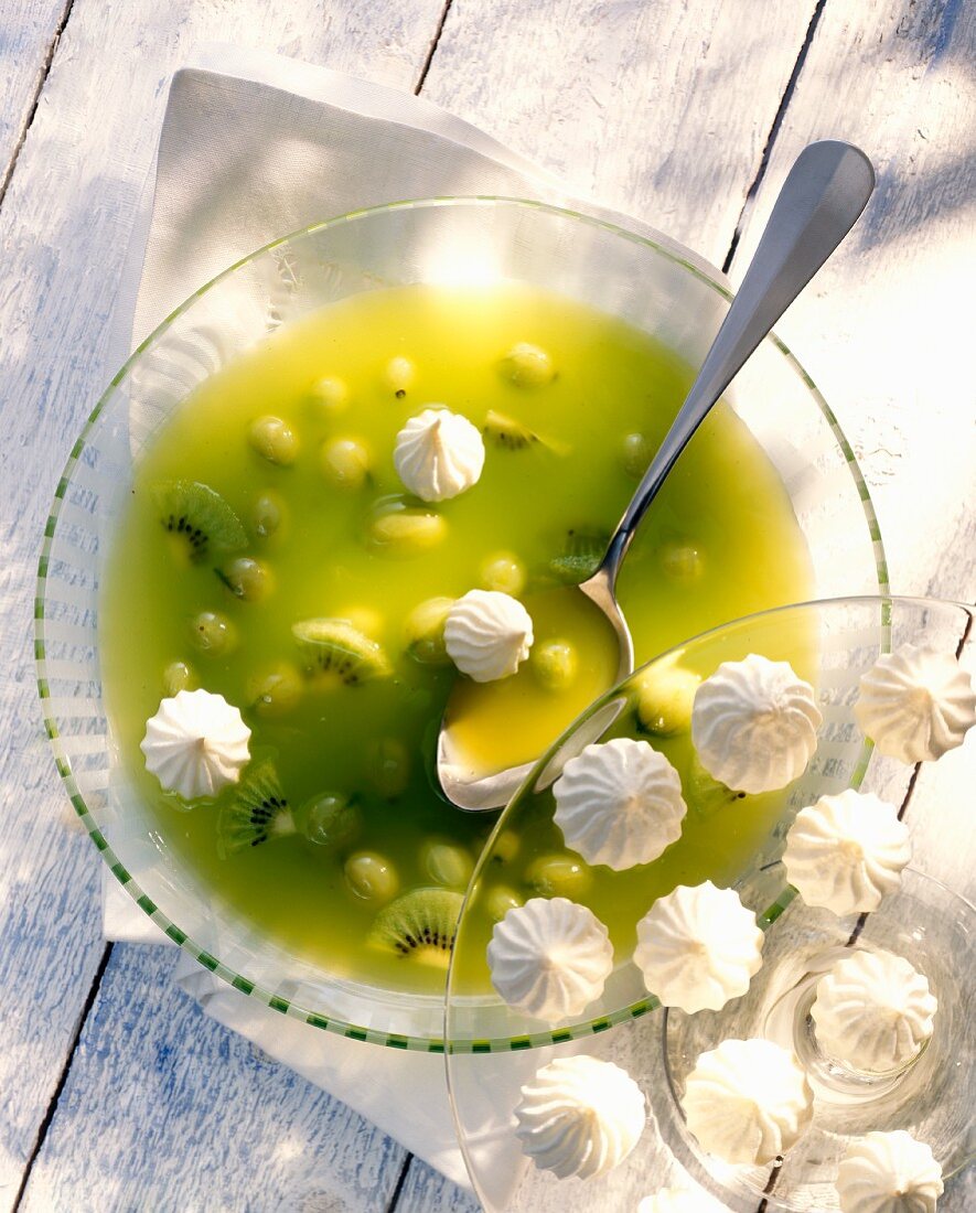 Cold gooseberry & kiwi soup with meringues in glass plate