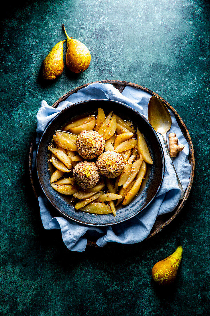 Ayurvedic rice pudding balls in hazelnut coating on pear ragout