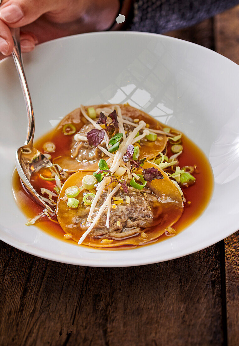 Ravioli with beef cheeks in consommé