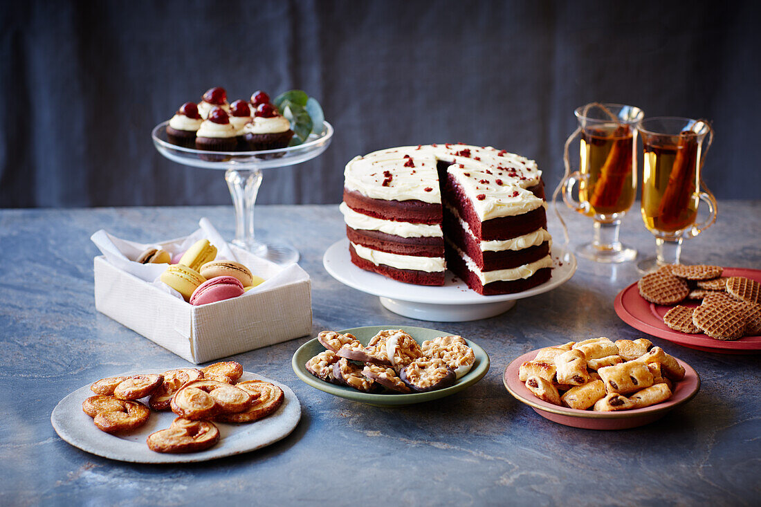 Red velvet cake with cream cheese icing and assorted pastries