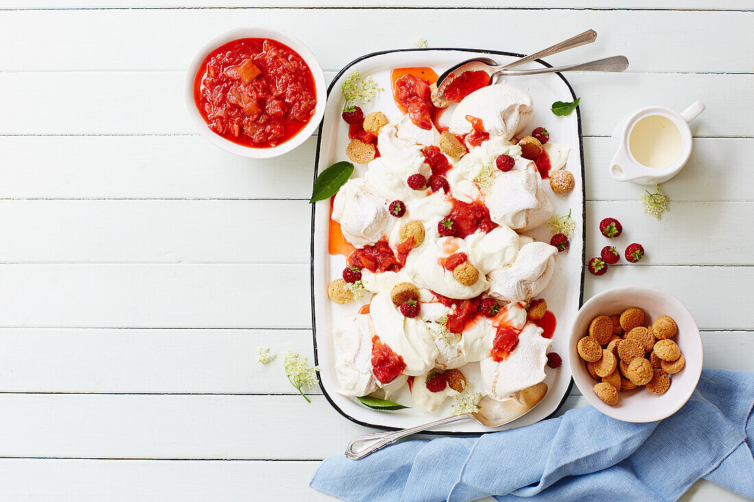 Rhubarb dessert with meringue, cream, amaretti and strawberries