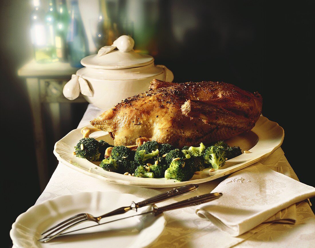 Roast duck with broccoli on serving platter