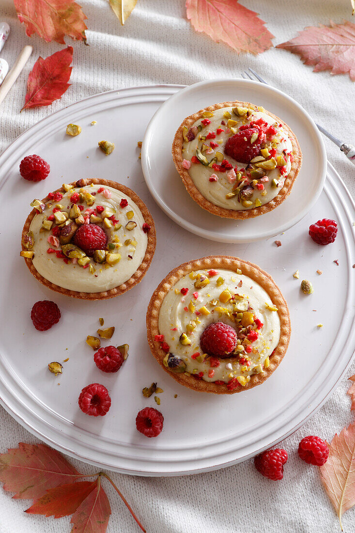 Pistachio mousse tartlets with raspberries