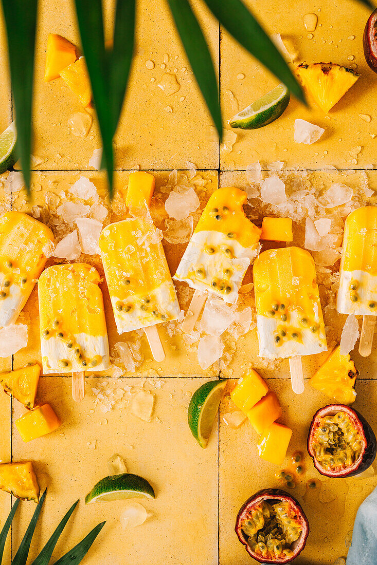 Mango and coconut popsicles with passion fruit
