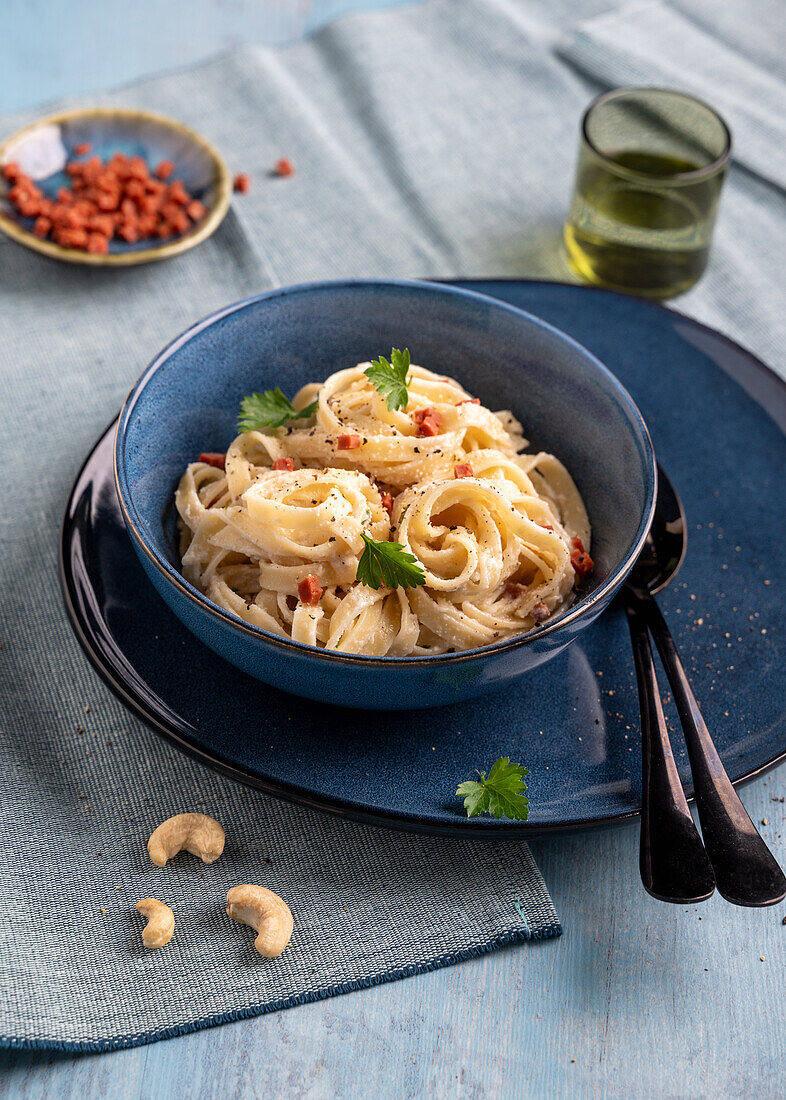 Vegan pasta carbonara with cashew cream and ham substitute