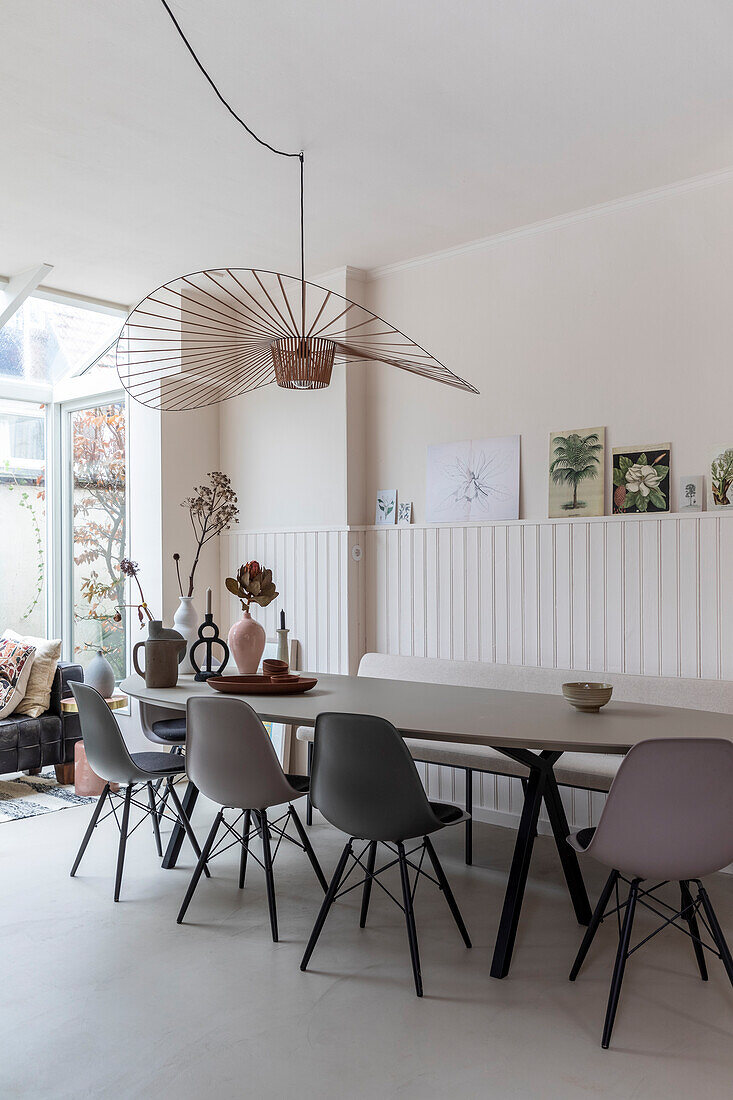 Dining room with modern pendant lamp and large table