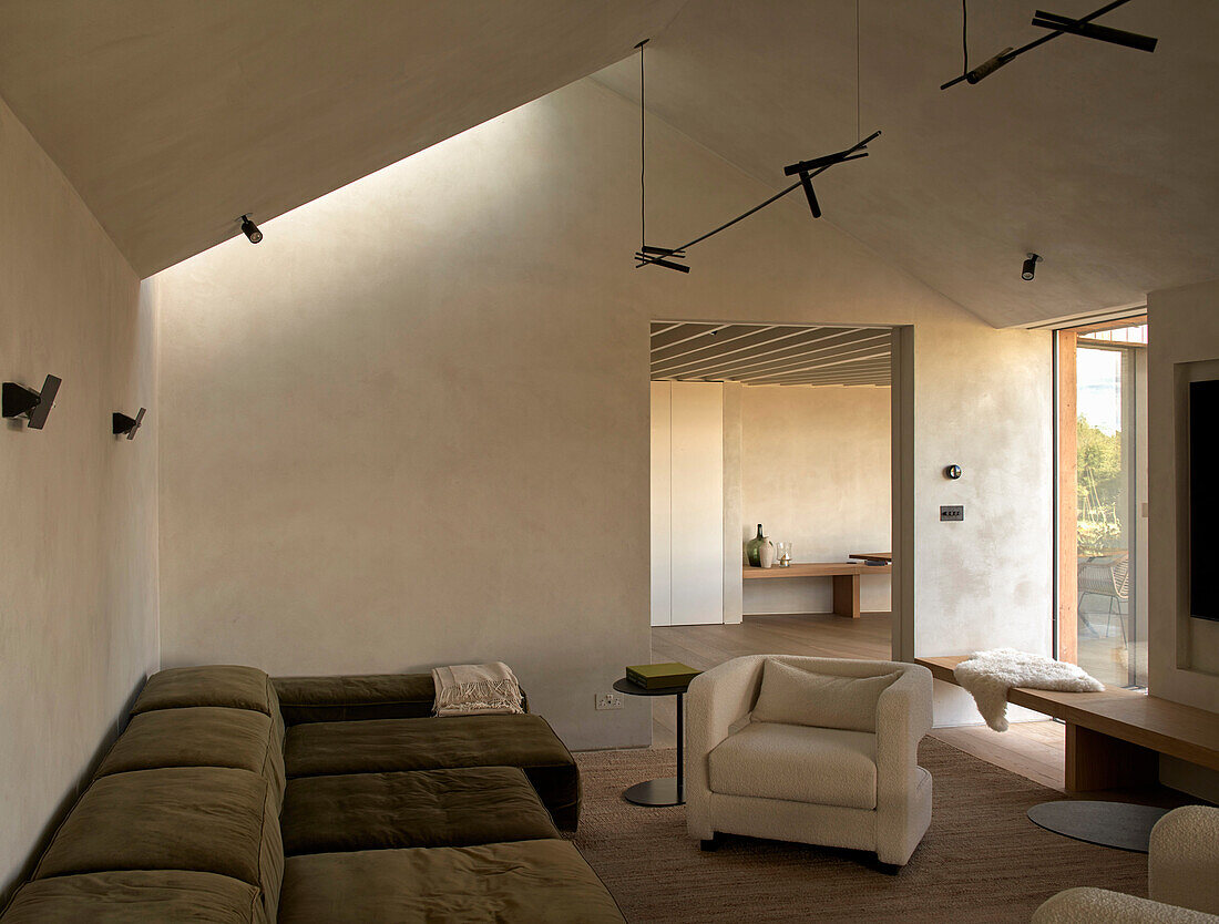 Olive green upholstered sofa and white armchair in the living room (Man Cave)