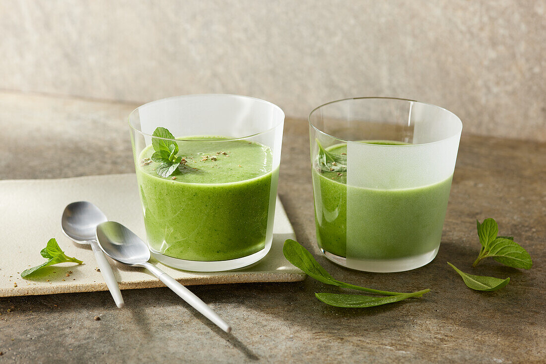 Green spinach smoothie with cucumber, chilli, avocado and herbs