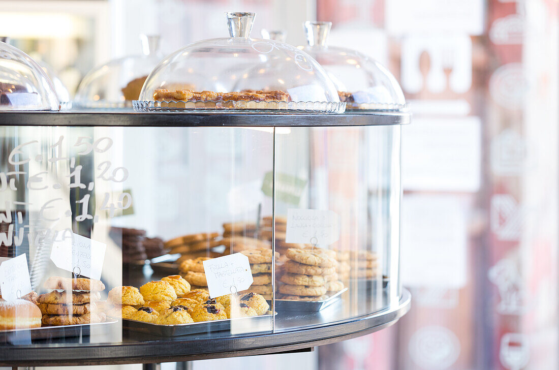 Showcase with cookies and muffins in the bakery