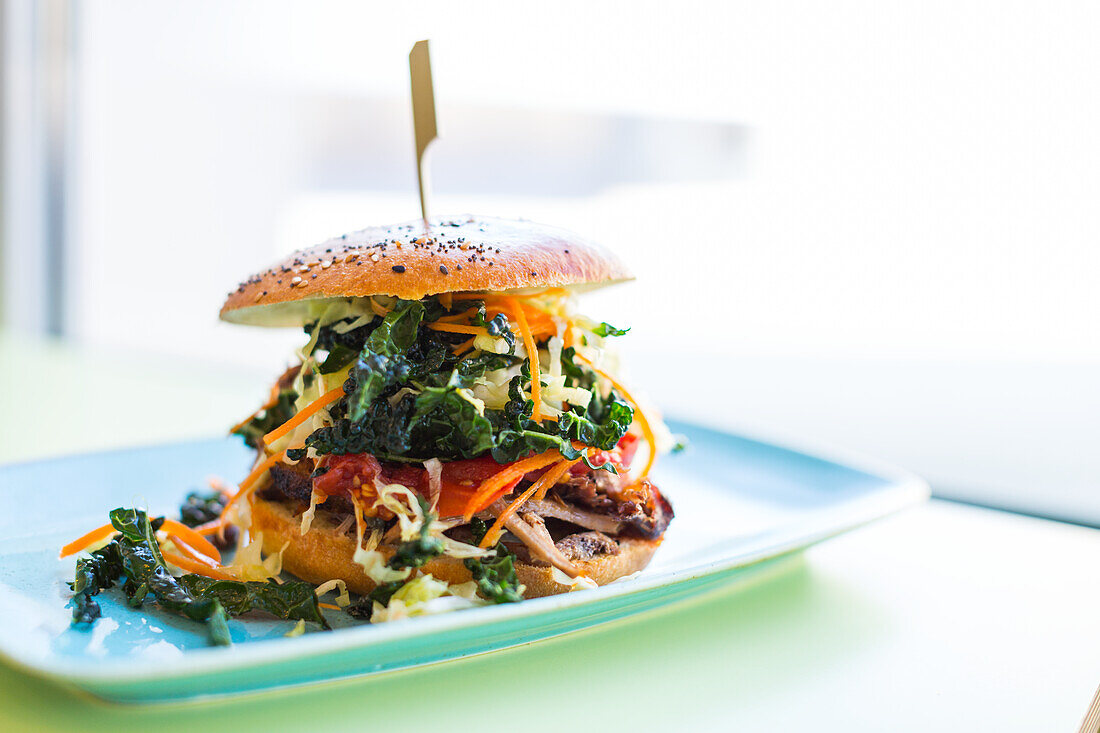 Hamburger with black cabbage, carrots, tomatoes and beef