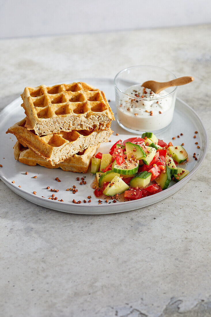 Buckwheat waffles with tomato and cucumber salad