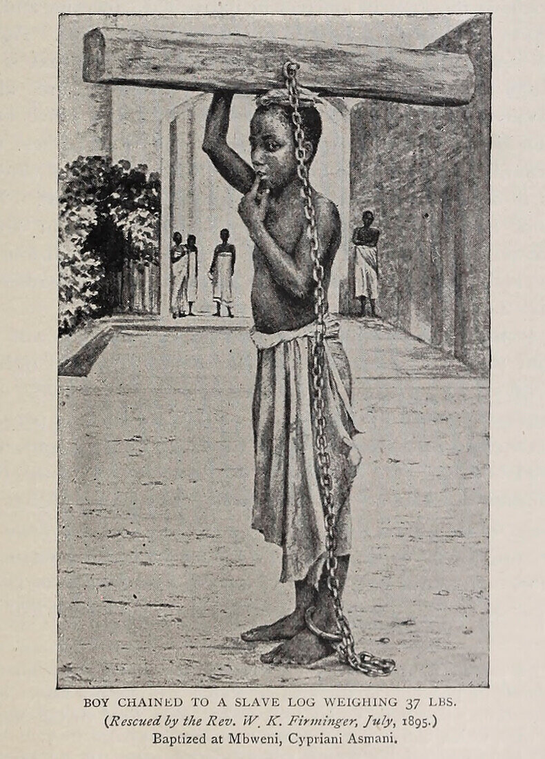 Boy chained to slave log