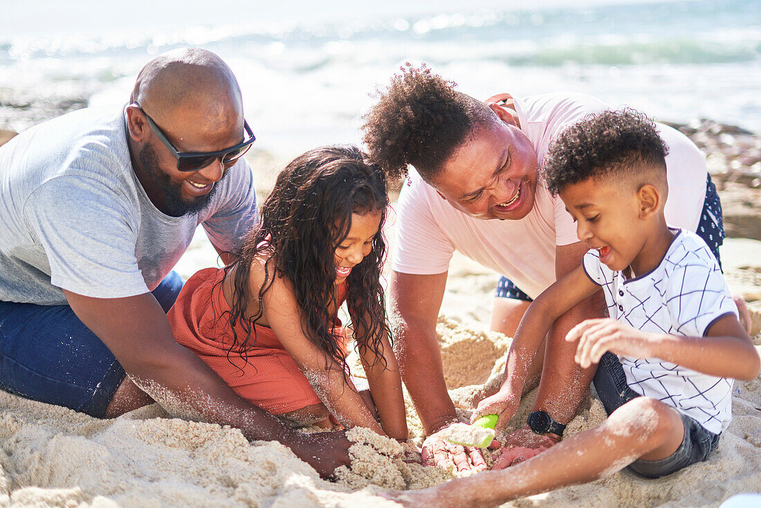 Family playing in sand on beach