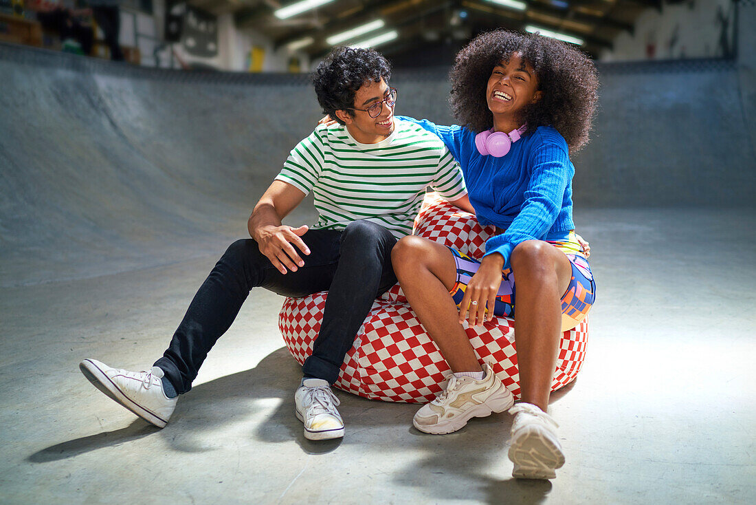 Young couple laughing on bean bag chair