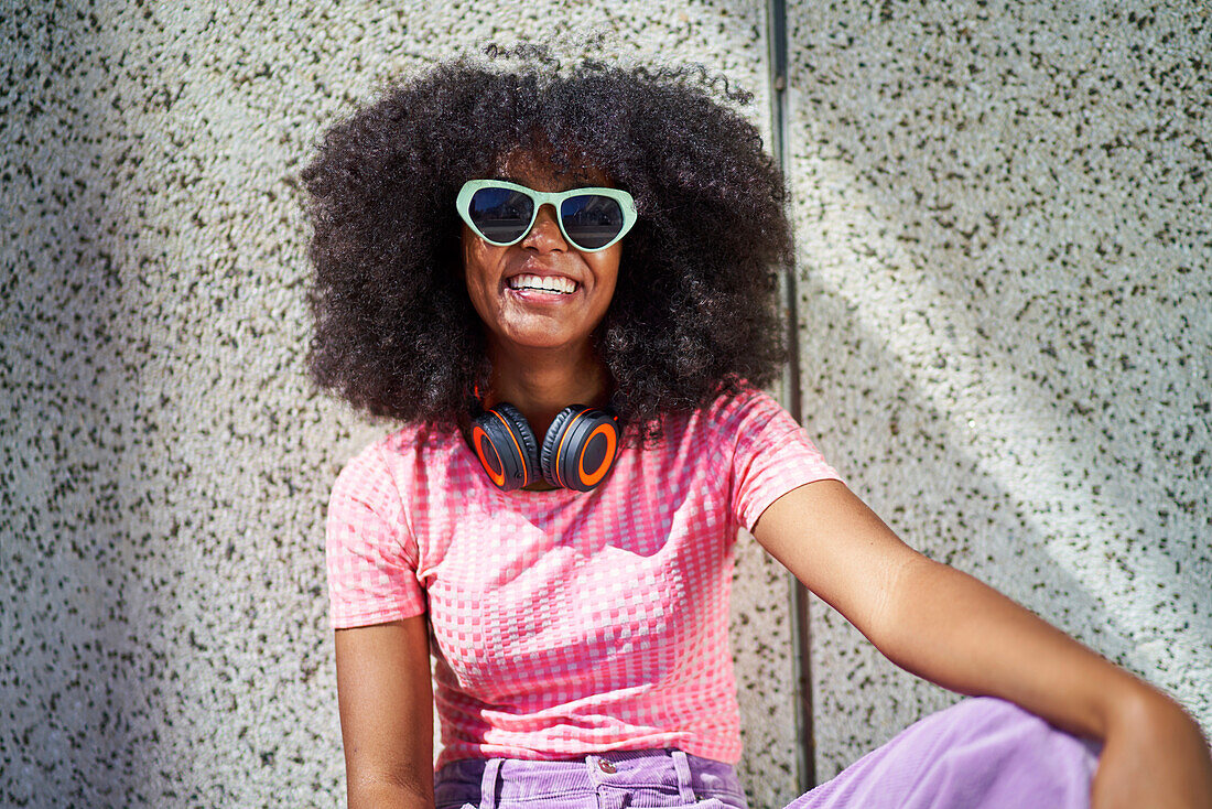 Young woman in sunglasses with headphones