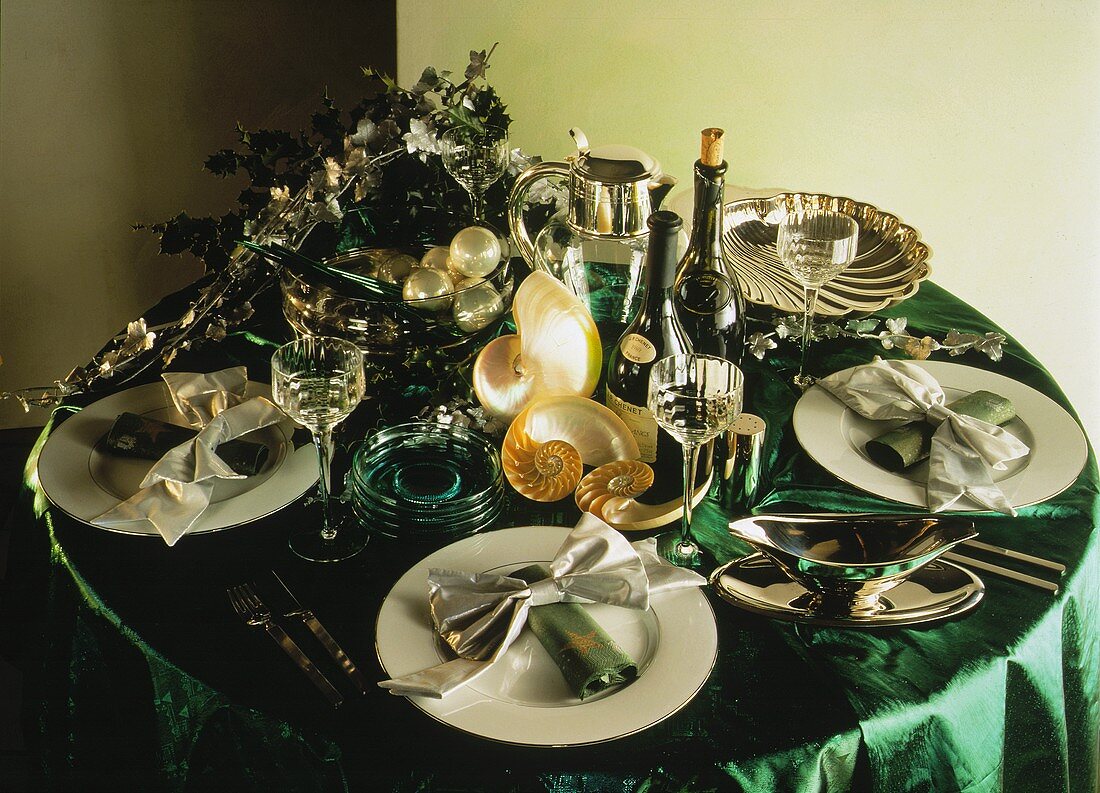 Festive table with shells, pearls, green tablecloth