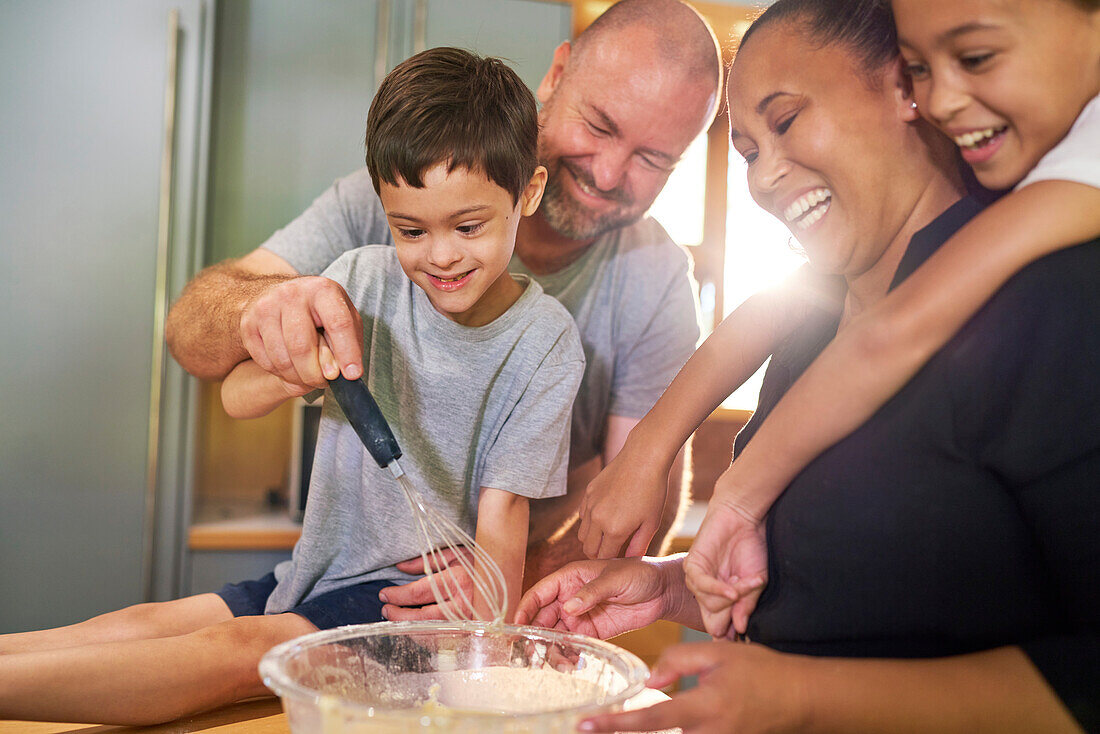 Family baking together in kitchen