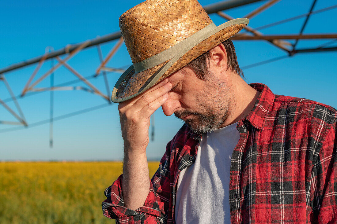 Stressed farmer in field