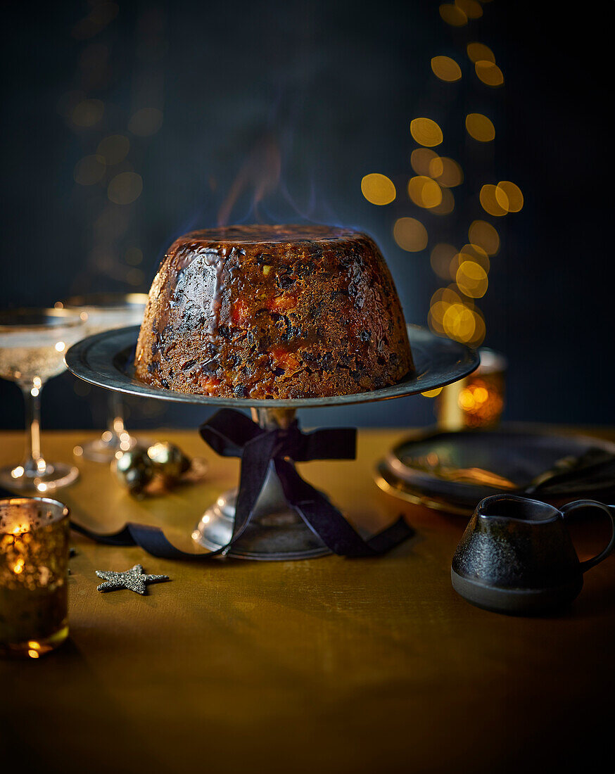 Flambéed Christmas pudding with citrus fruits from the pressure cooker