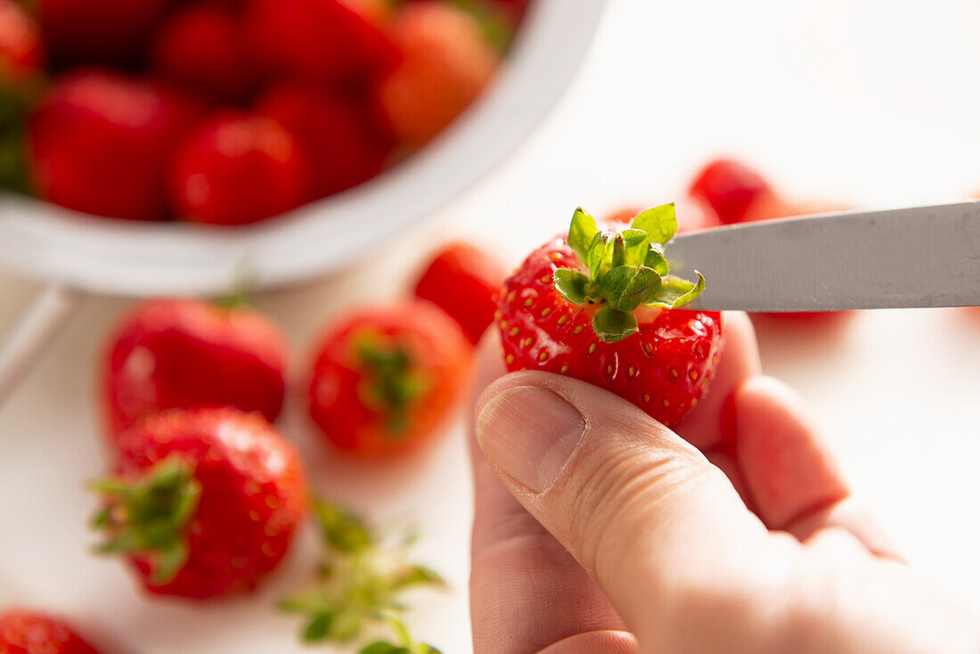 Remove the stems from strawberries