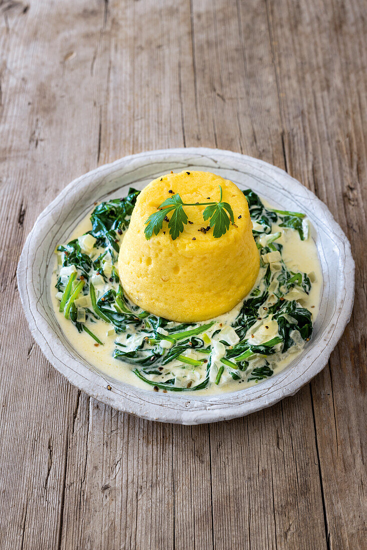 Potato soufflé on creamed spinach