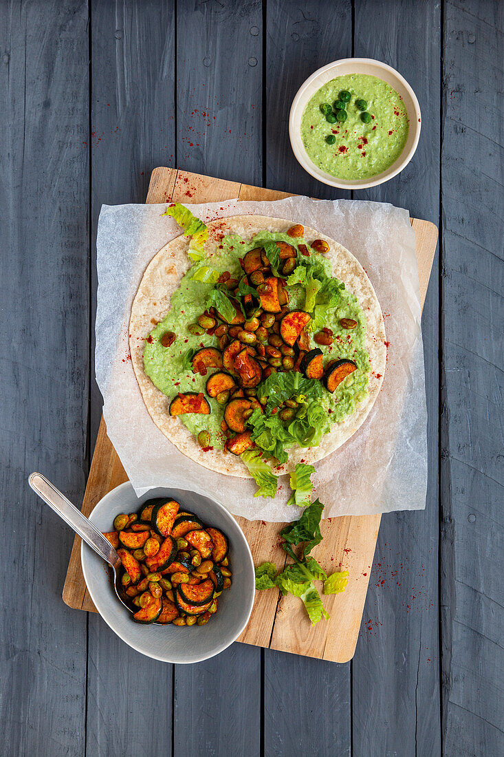 Green vegetable wraps with pea cream, edamame and courgette