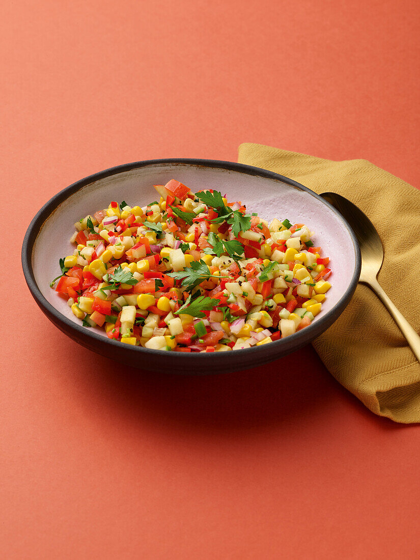 Colourful summer corn salad with apple and peppers