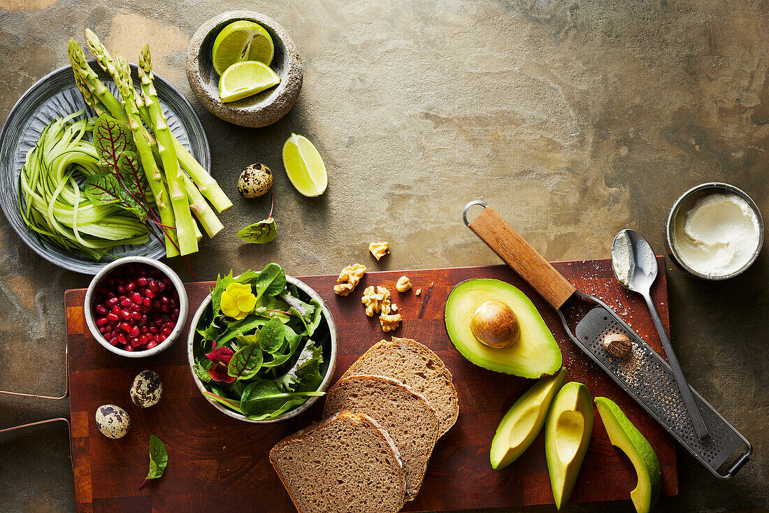 Asparagus, limes, pomegranate seeds, bread, walnut kernels, avocado, nutmeg